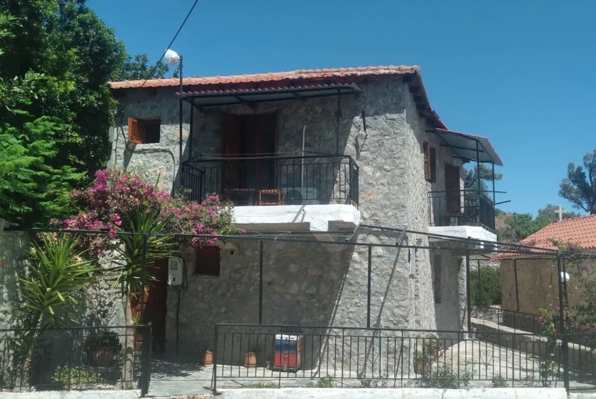 Two-story stone house for sale.