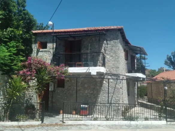 Two-story stone house for sale.